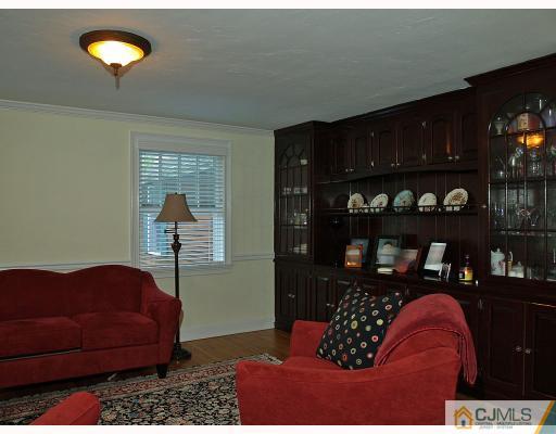 5 Longview Road Edison, NJ 08820 - Photo 2 of 10 a living room with furniture a rug and a bookshelf