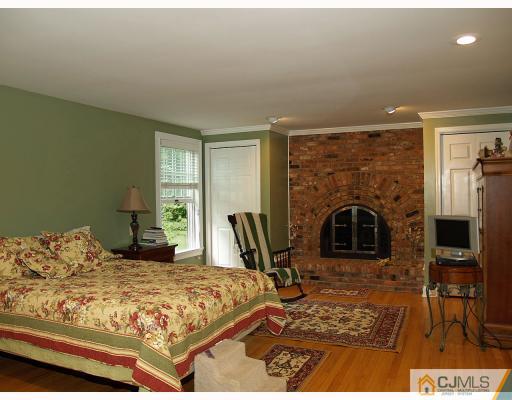 5 Longview Road Edison, NJ 08820 - Photo 7 of 10 a bedroom with a bed a table and chair