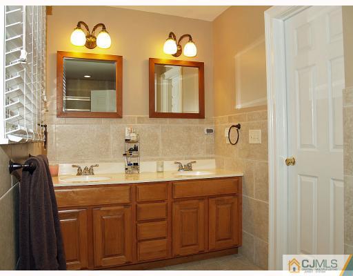 5 Longview Road Edison, NJ 08820 - Photo 8 of 10 a bathroom with a double vanity sink and a mirror