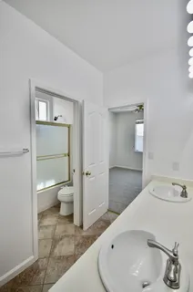 an empty room with closet and fan