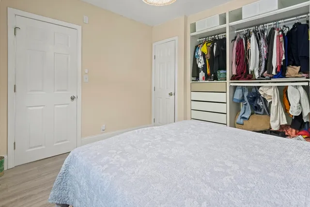 a view of a bedroom with clothes and shoes