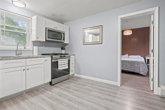 a kitchen with a sink a stove and cabinets