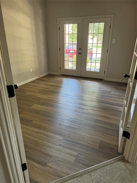 236 Archer Way Forney, TX 75126 - Photo 20 of 35 a view of an empty room with wooden floor and a window