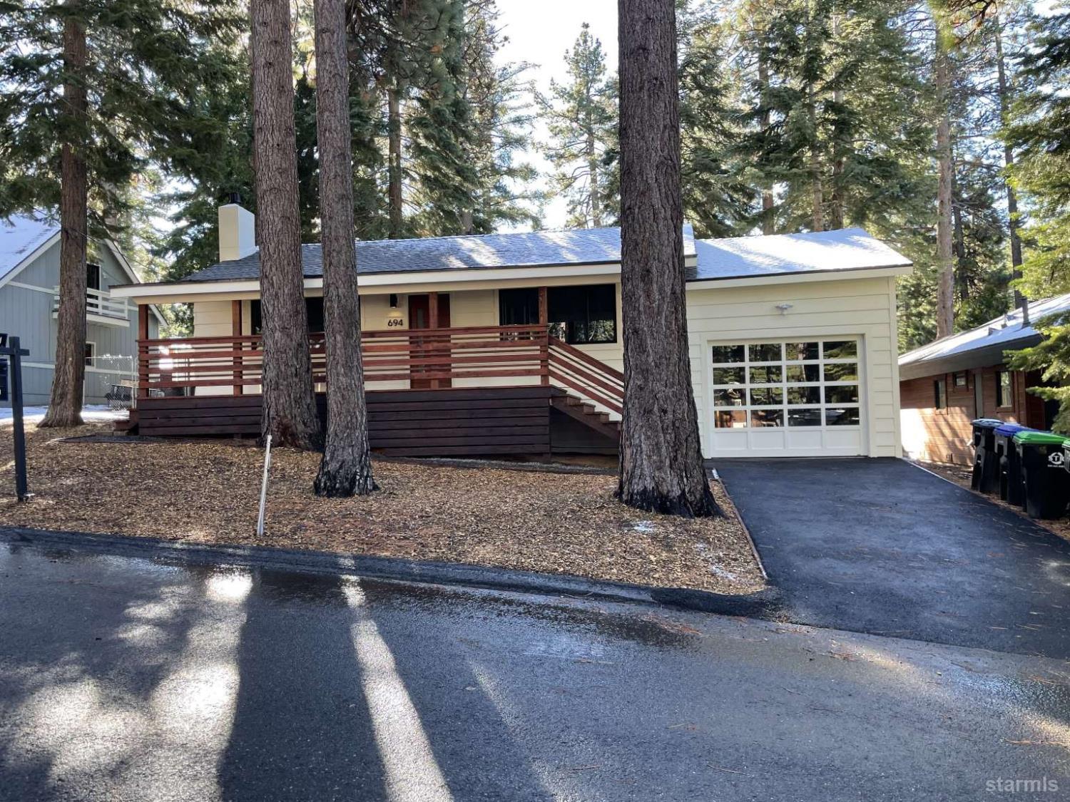 694 Sand Harbor Road South Lake Tahoe, CA 96150 - Photo 1 of 20 a front view of a house with garden
