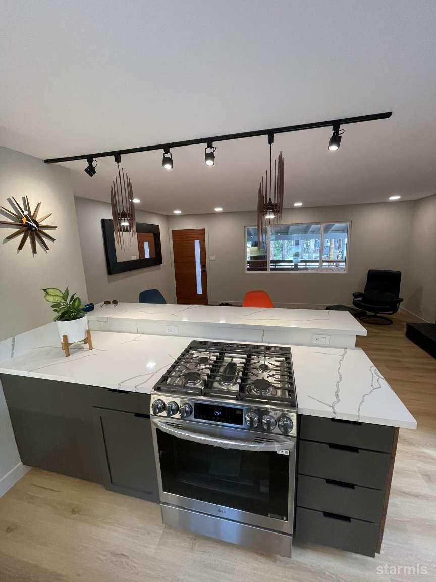 694 Sand Harbor Road South Lake Tahoe, CA 96150 - Photo 11 of 20 a kitchen with stainless steel appliances kitchen island a stove and a sink