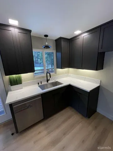 a living room with stainless steel appliances kitchen island granite countertop furniture and a large mirror