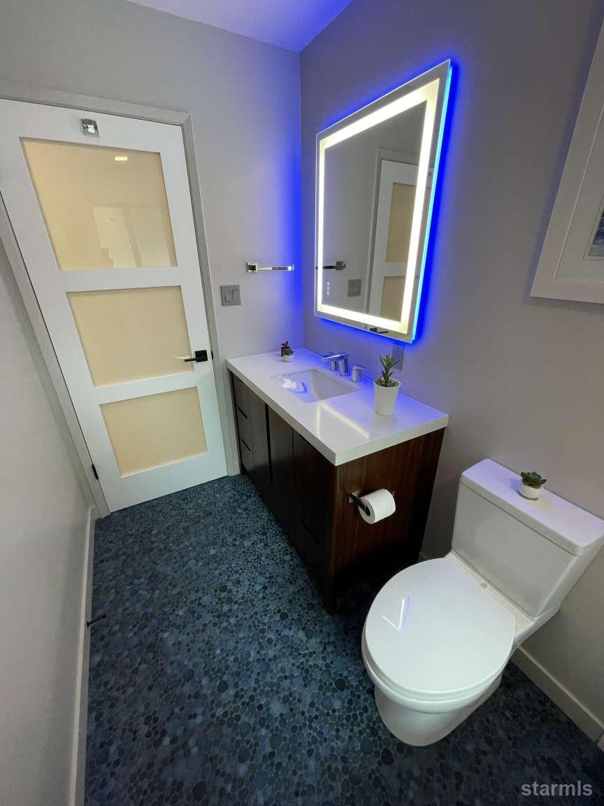 694 Sand Harbor Road South Lake Tahoe, CA 96150 - Photo 16 of 20 a bathroom with a toilet sink and mirror