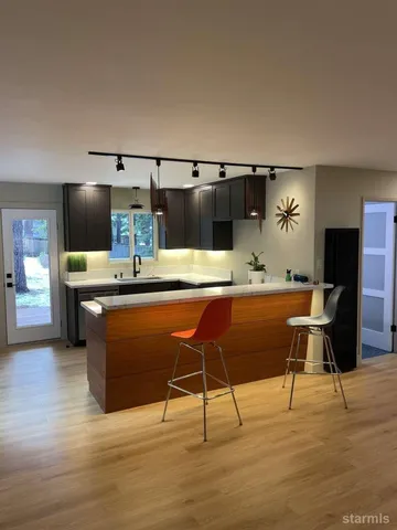 a kitchen with stainless steel appliances kitchen island granite countertop a sink and cabinets