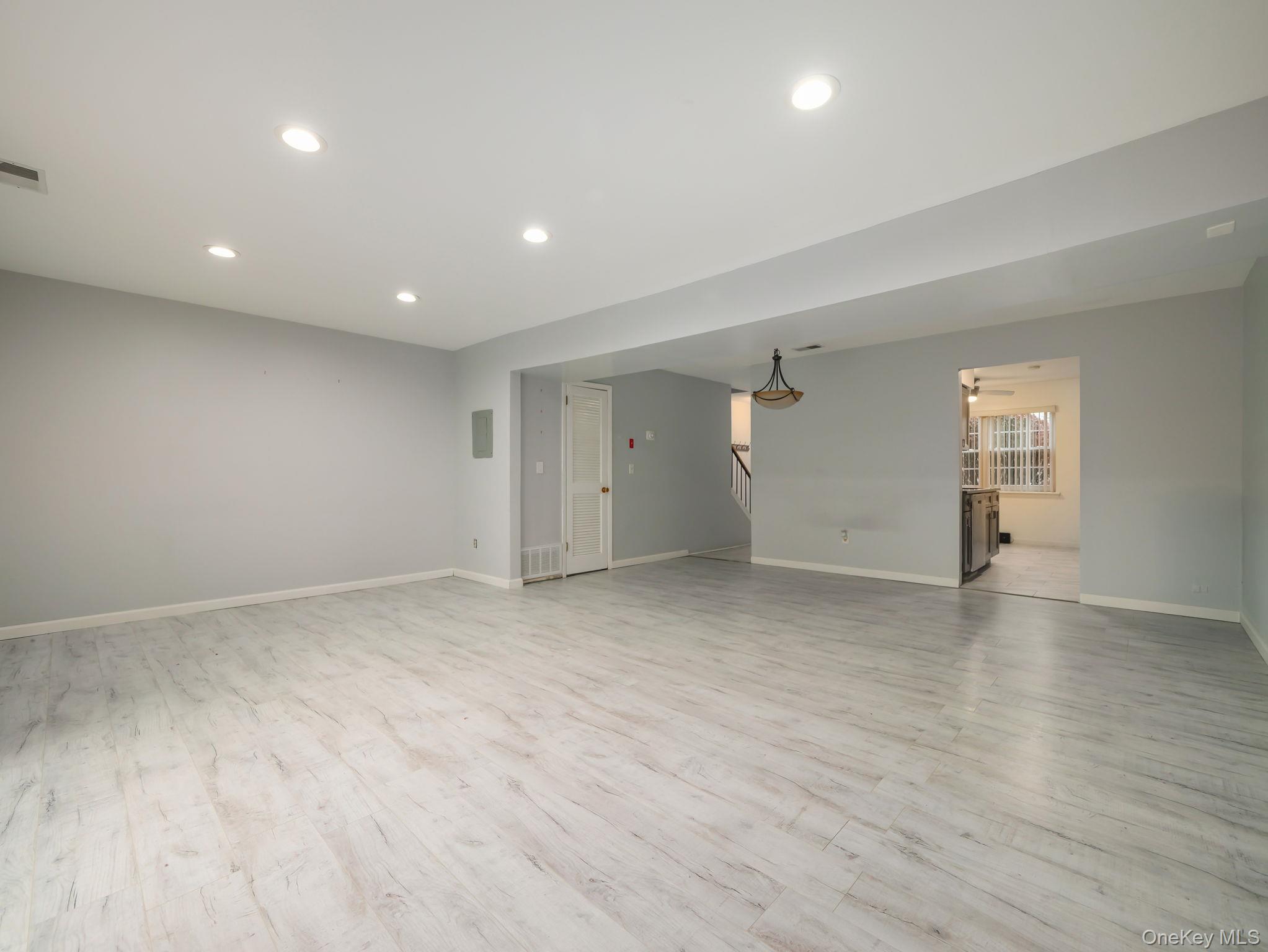 276 Temple Hill Road, Unit 707 New Windsor, NY 12553 - Photo 12 of 23 an empty room with wooden floor and windows