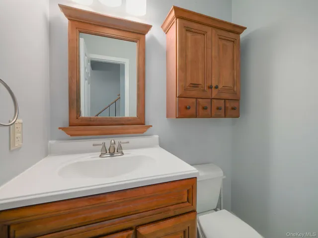 a bathroom with a toilet sink and mirror