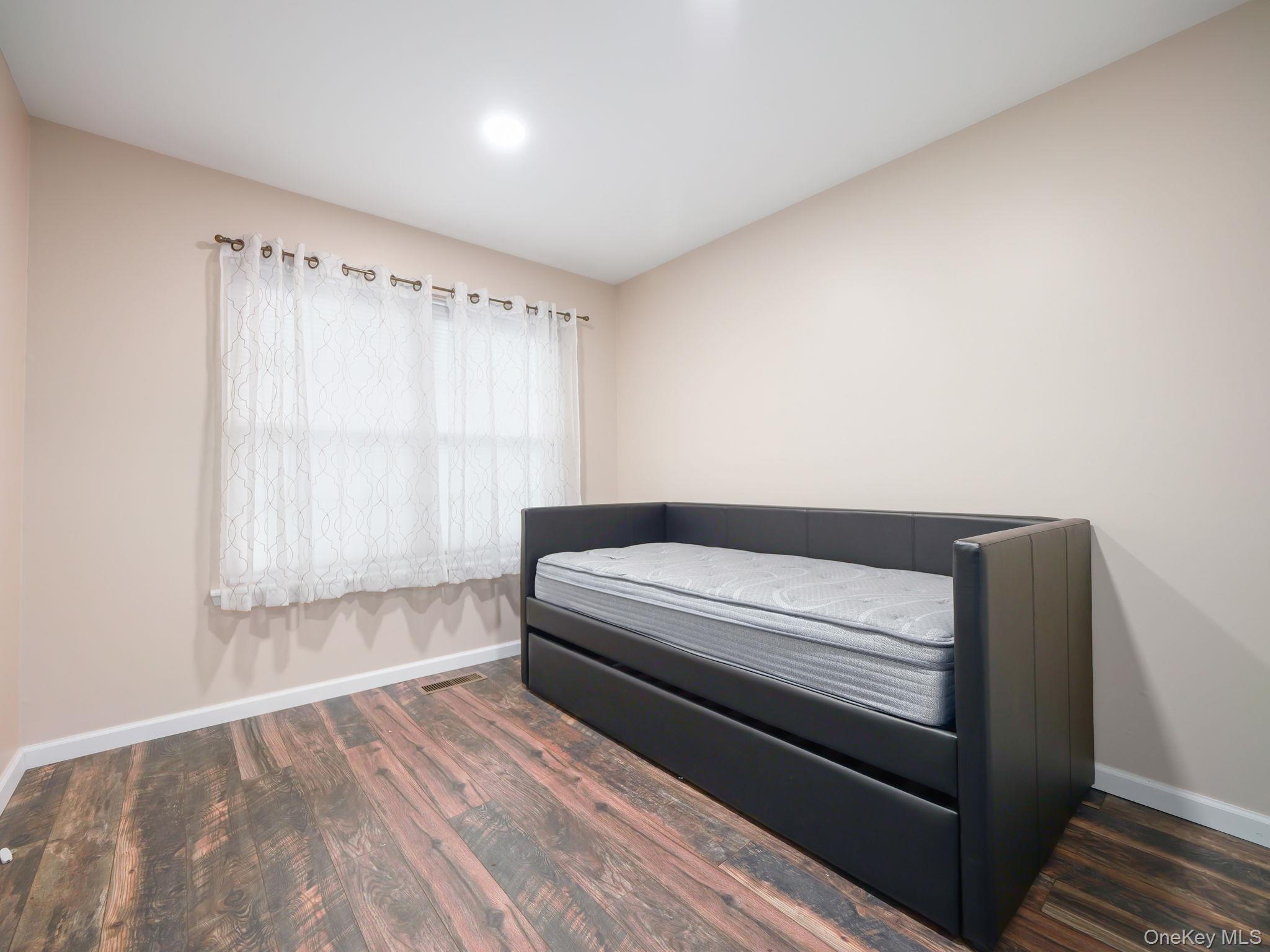 276 Temple Hill Road, Unit 707 New Windsor, NY 12553 - Photo 15 of 23 a bedroom with a bed and a window