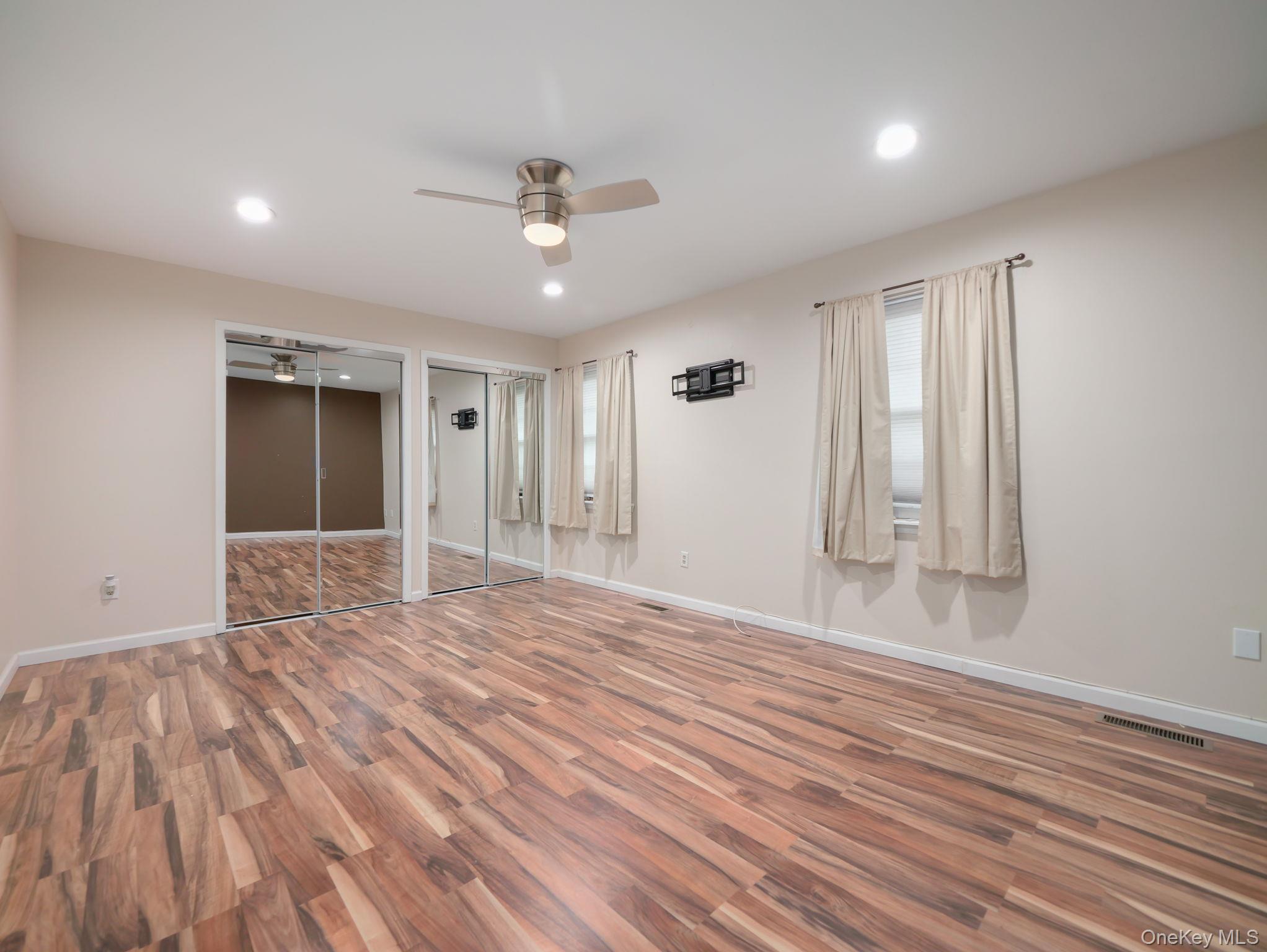 276 Temple Hill Road, Unit 707 New Windsor, NY 12553 - Photo 18 of 23 a view of an empty room with wooden floor and a window