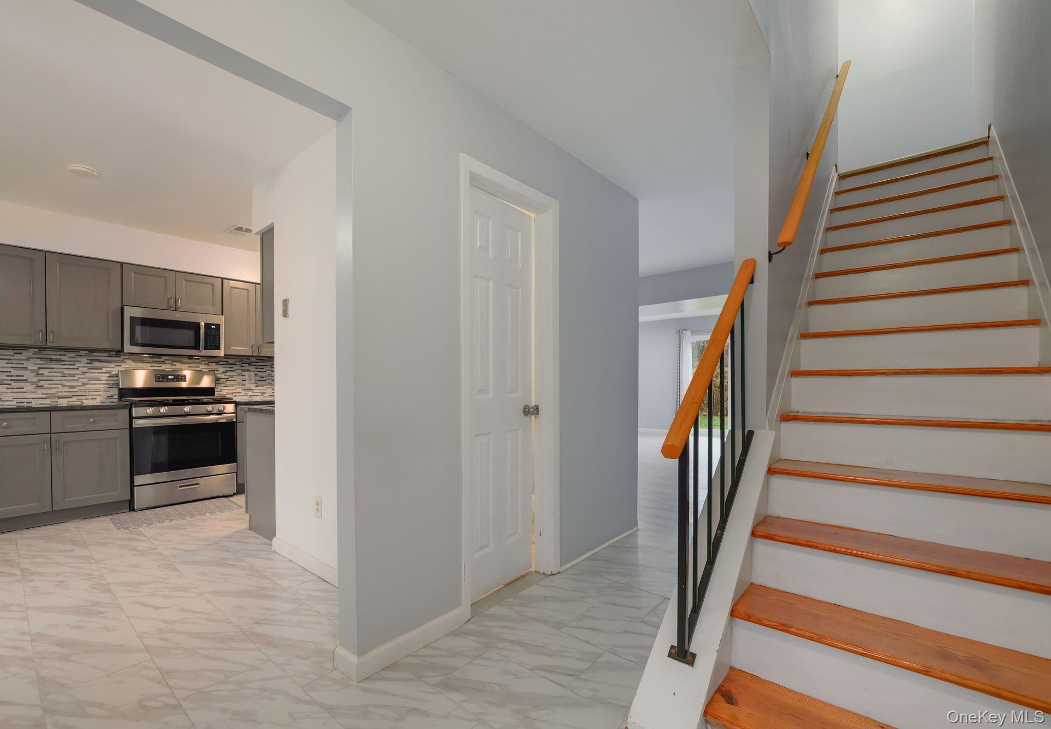 276 Temple Hill Road, Unit 707 New Windsor, NY 12553 - Photo 4 of 23 a kitchen with a refrigerator and a stove top oven