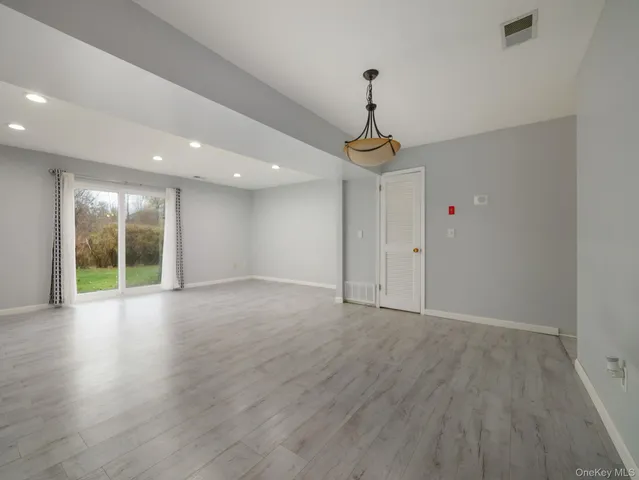 a view of an empty room with glass door
