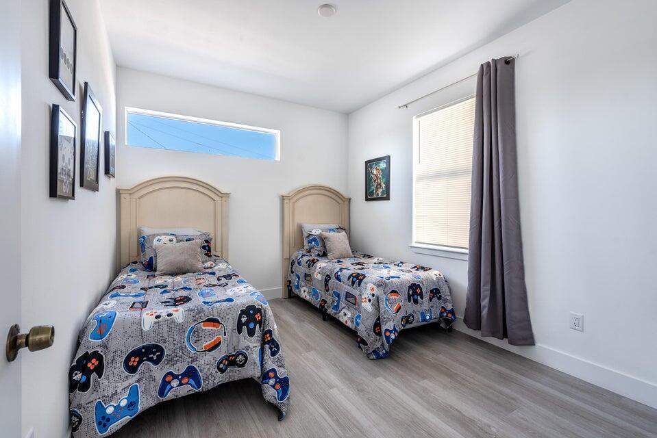 427 Northwest 13th Avenue Boynton Beach, FL 33435 - Photo 11 of 20 a bedroom with two beds and a large mirror next to a window