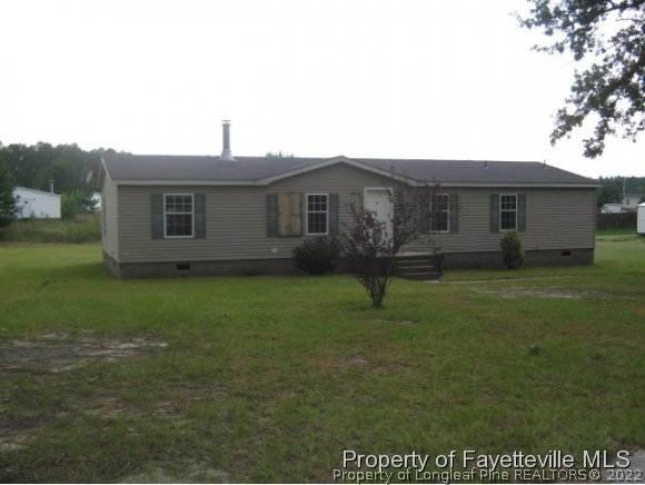 5978 Parkton Road Hope Mills, NC 28348 - Photo 1 of 9 a house view with a garden space