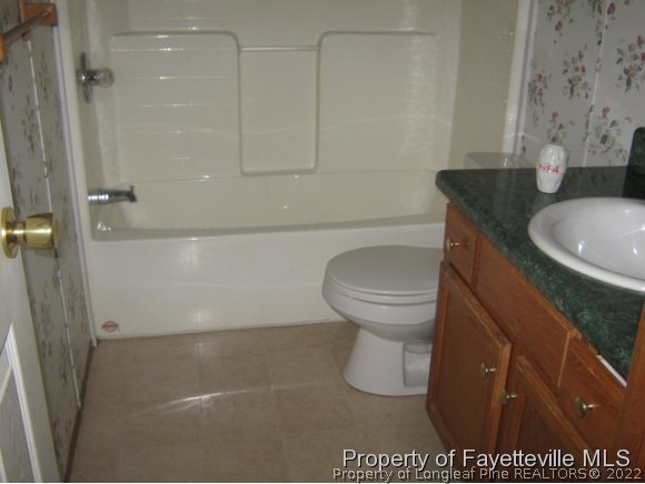 5978 Parkton Road Hope Mills, NC 28348 - Photo 7 of 9 a bathroom with a sink toilet and shower