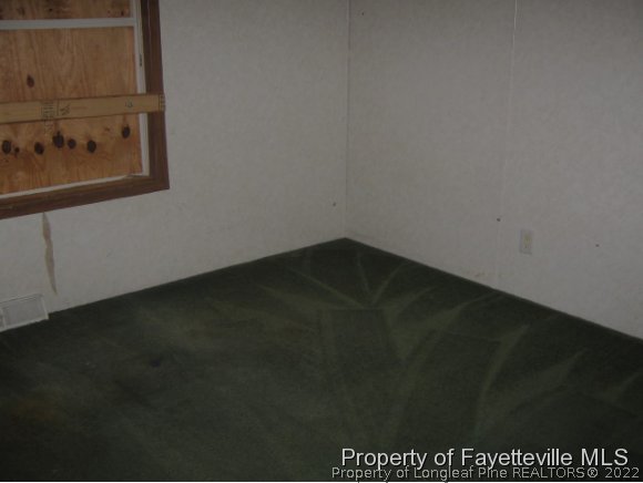 5978 Parkton Road Hope Mills, NC 28348 - Photo 8 of 9 an empty room with a wooden floor
