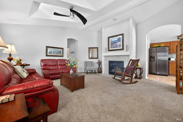 a living room with furniture a fireplace and next to a window