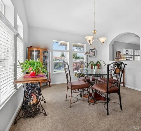 a dining room filled with furniture and a chandelier