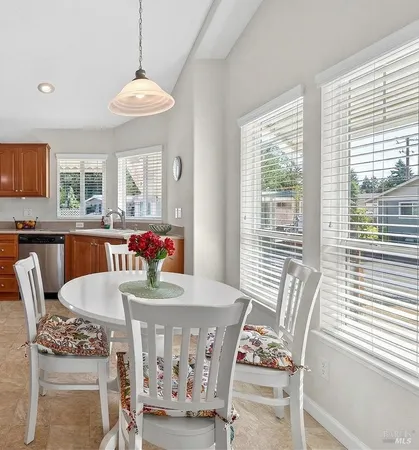 a view of a dining room with furniture window and outside view