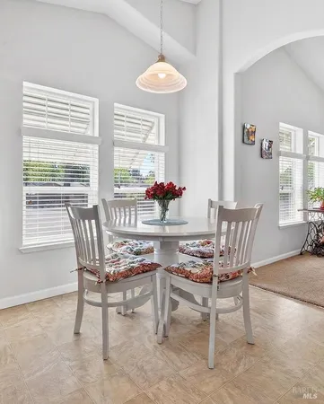 a dining room with furniture and window