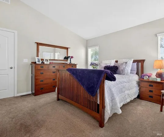 a spacious bedroom with a bed and a dresser