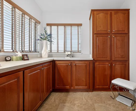 a bathroom with a sink a mirror and next to a window