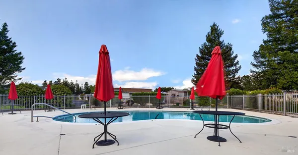 a view of a house with swimming pool and sitting area