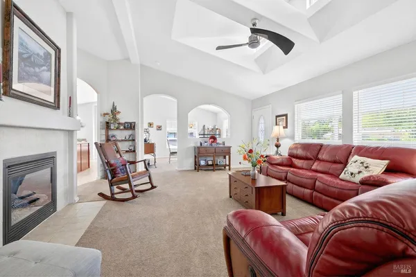 a living room with furniture a fireplace and window