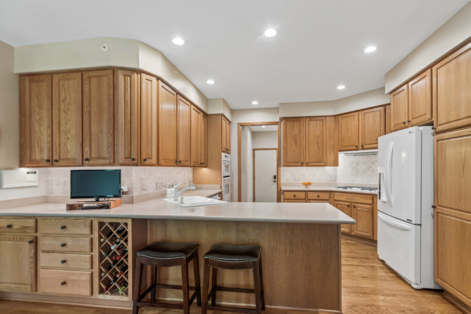 10907 Red Hawk Lane Spring Grove, IL 60071 - Photo 14 of 44 a kitchen with granite countertop a refrigerator stove top oven and cabinets
