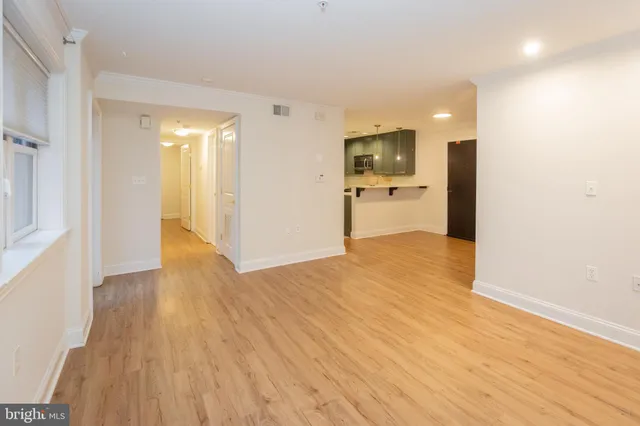 a view of a hallway with wooden floor