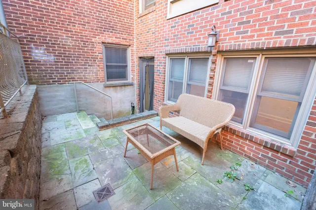 a view of a patio with a table and chairs and wooden floor