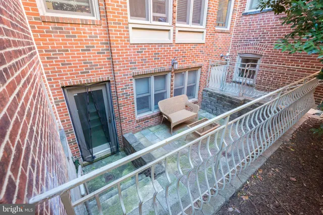 a balcony with wooden floor and furniture