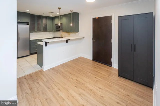 a kitchen with a sink and refrigerator