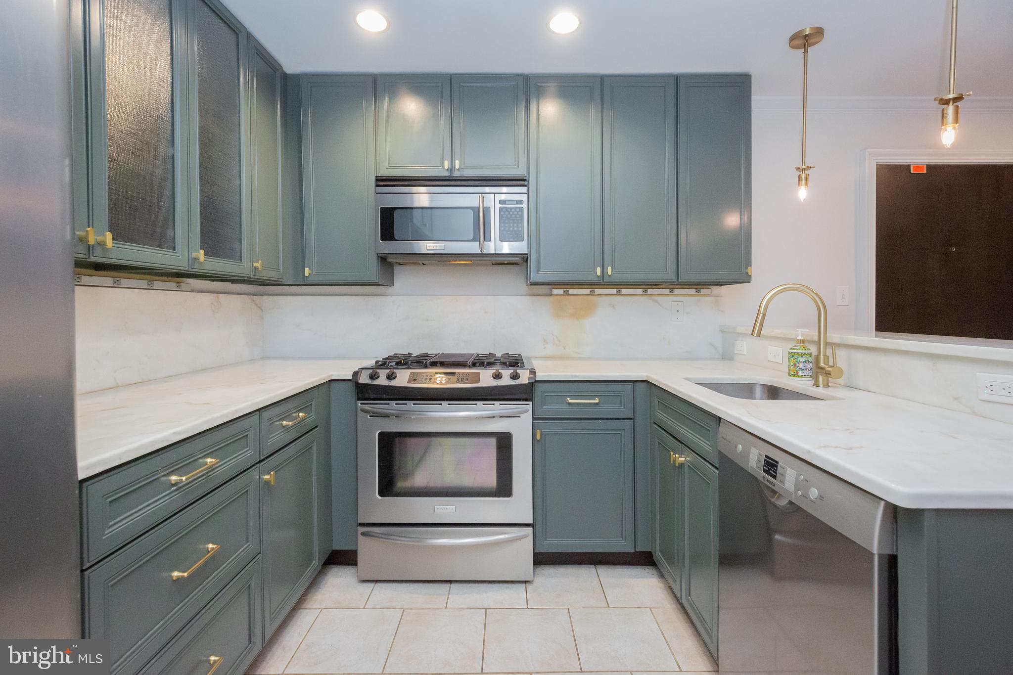 1323 Clifton Street Northwest, Unit 3 Washington, DC 20009 - Photo 7 of 32 a kitchen with stainless steel appliances granite countertop a sink and a stove