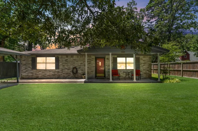 a front view of a house with a garden