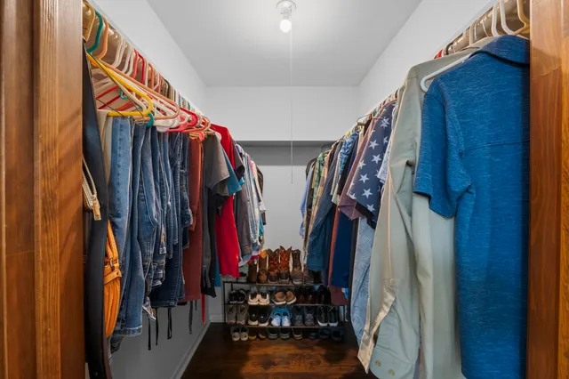 a view of walk in closet with clothes