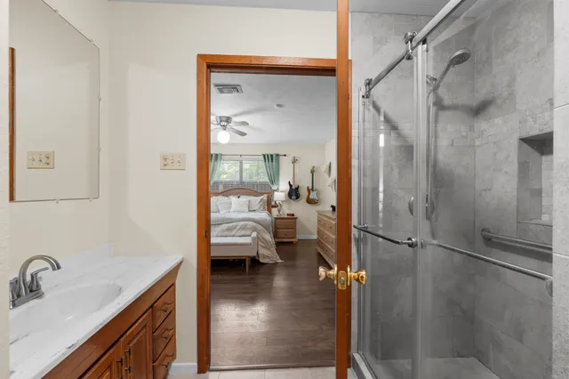 a en suite bathroom with a sink shower and a mirror