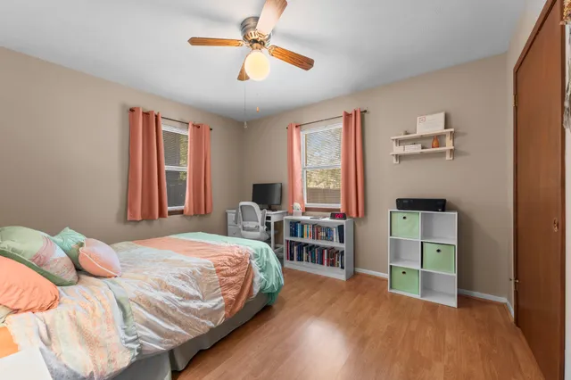 a bedroom with a bed and a chandelier