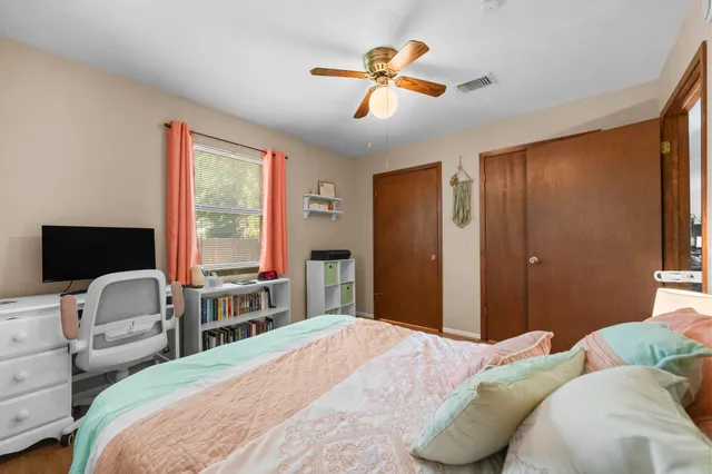 a bedroom with a bed a couch and a window