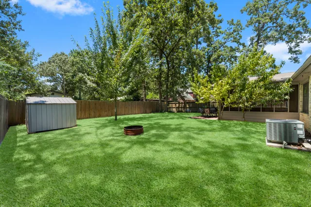 a backyard of a house with plants and tree