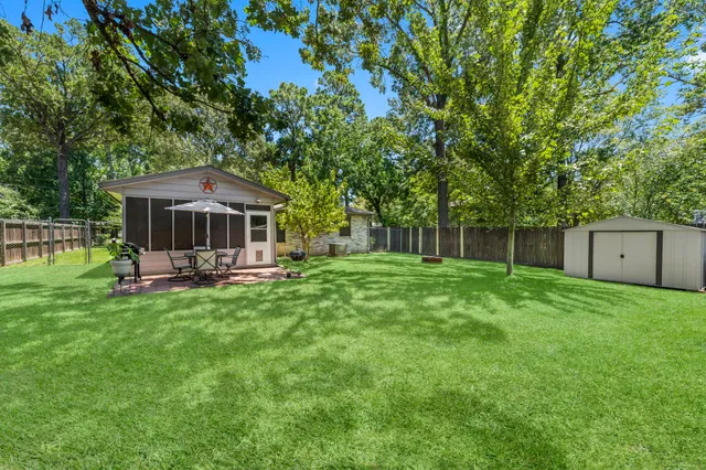a view of a house with backyard and sitting area