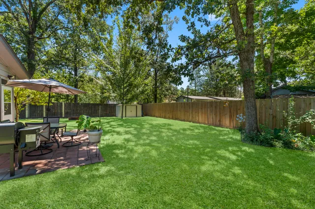 a view of a chair and table in the garden