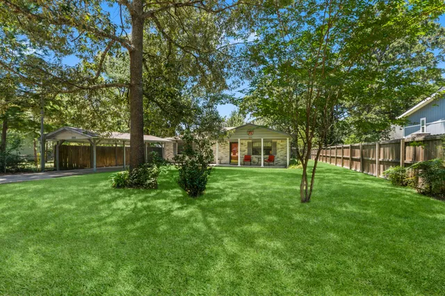 a view of a house with a backyard