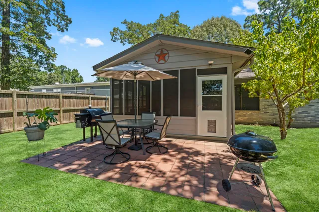 a view of a house with backyard sitting area and garden