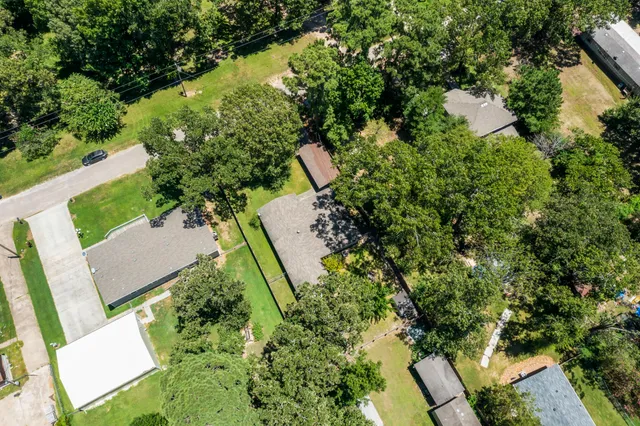 an aerial view of a house with a yard and outdoor seating