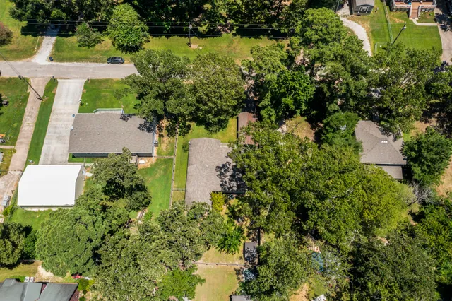 an aerial view of a house with a yard and lake view