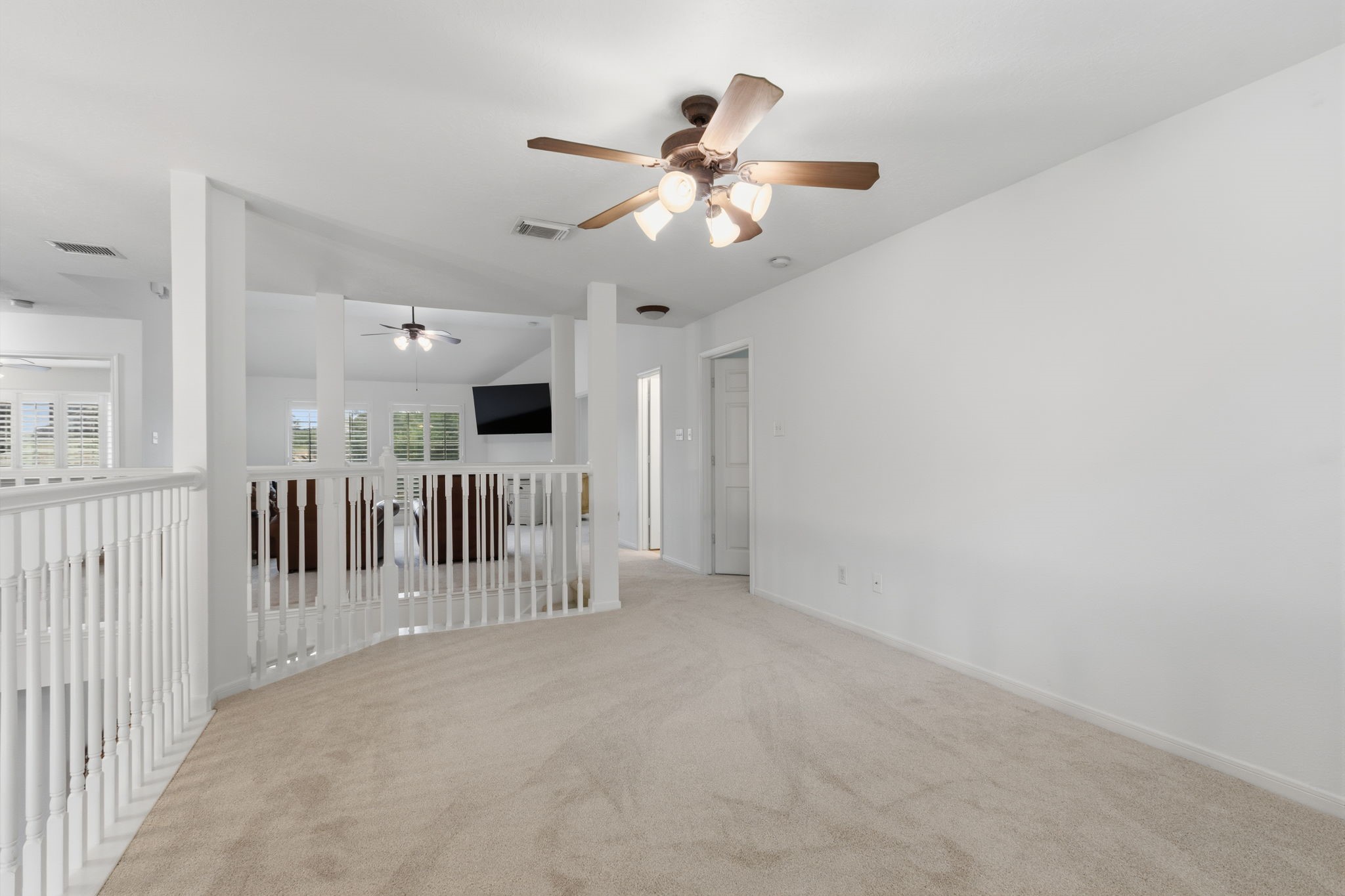 8419 Marchelle Lane Spring, TX 77379 - Photo 20 of 42 a view of a livingroom with a ceiling fan and hardwood floor