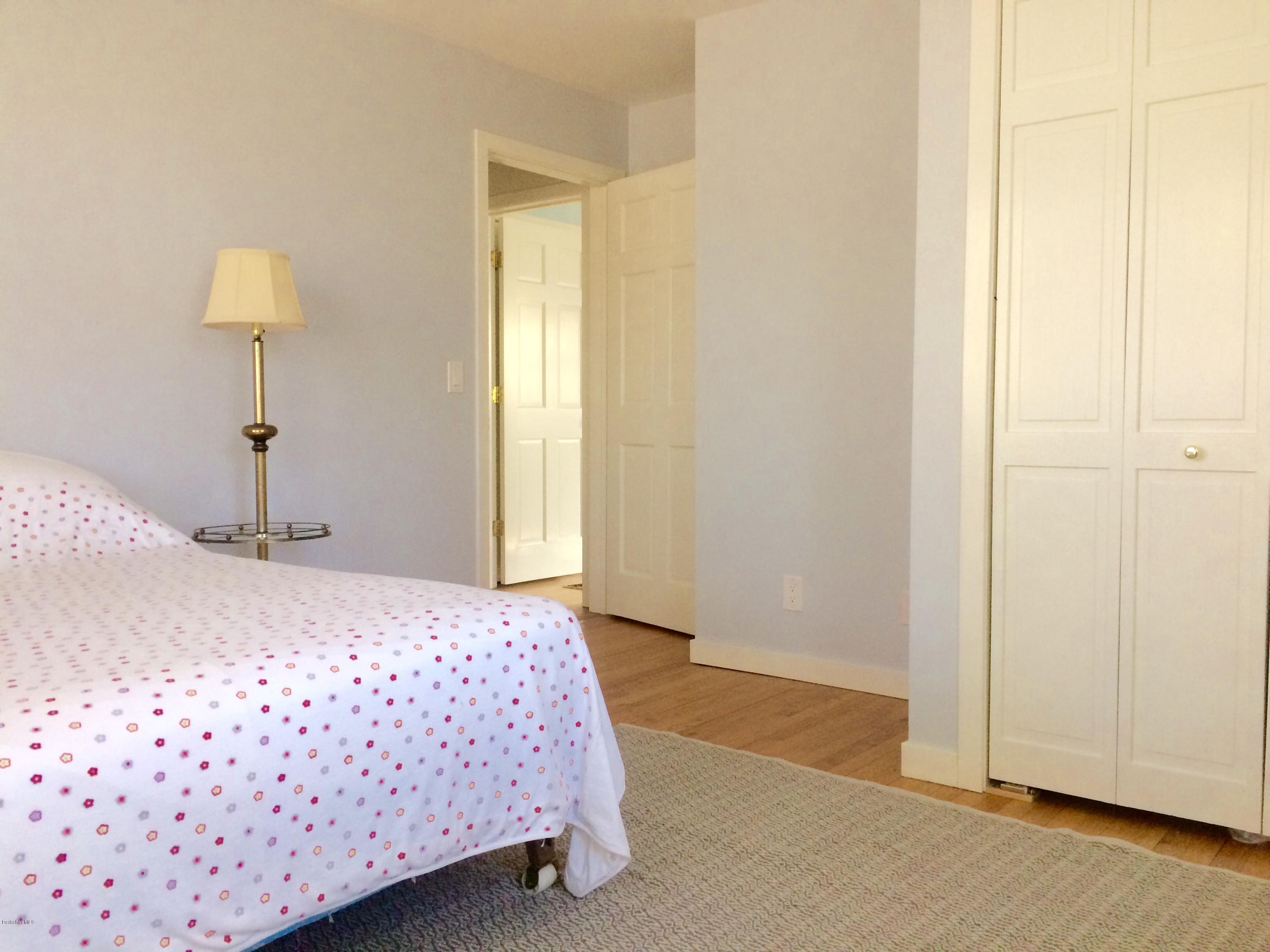 5 Hawthorne Road Lenox, MA 01240 - Photo 13 of 18 a bedroom with a bed and a lamp